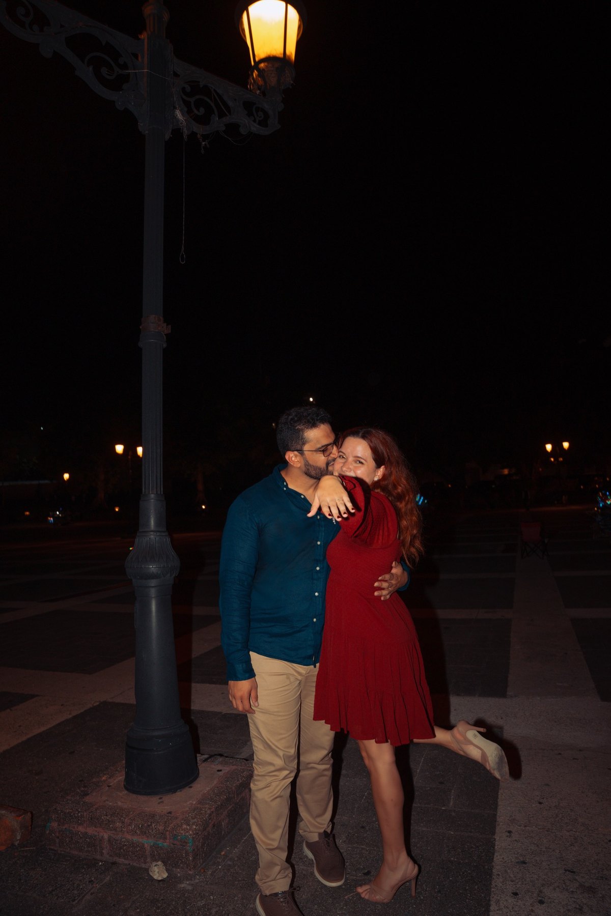 Couple embracing beside a streetlamp