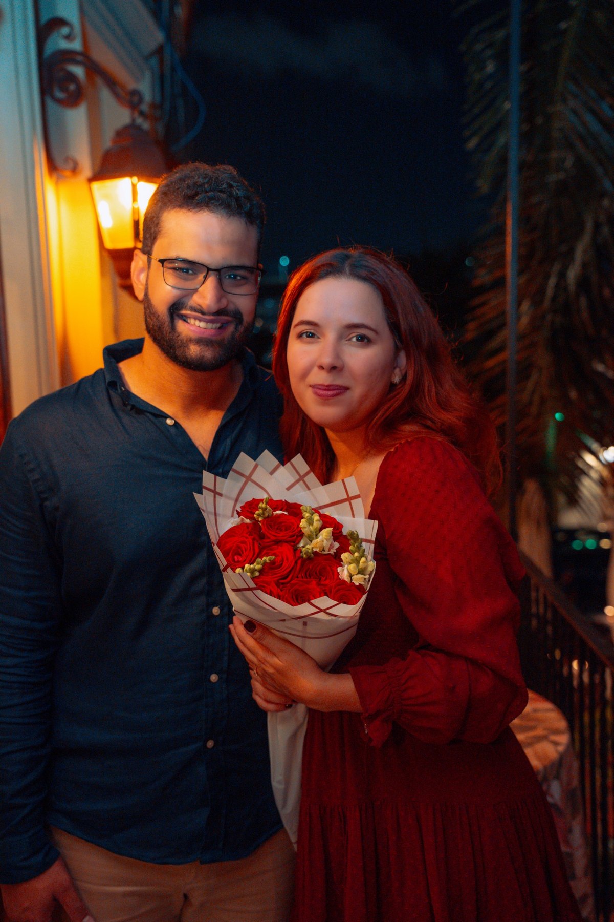 Warm nighttime portrait of a newly engaged couple