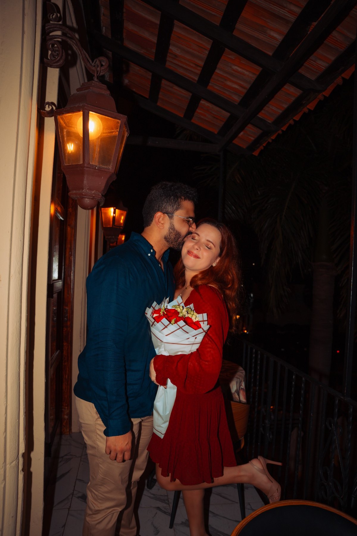 Couple sharing an affectionate bouquet moment