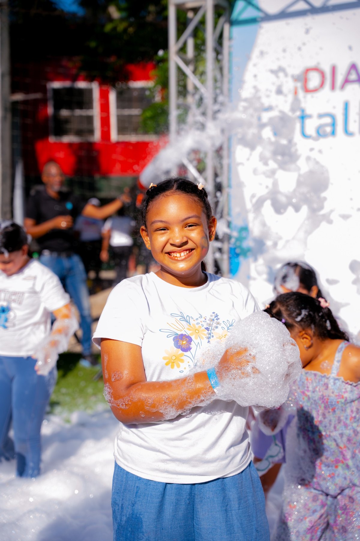Niña sonriendo con espuma durante el evento